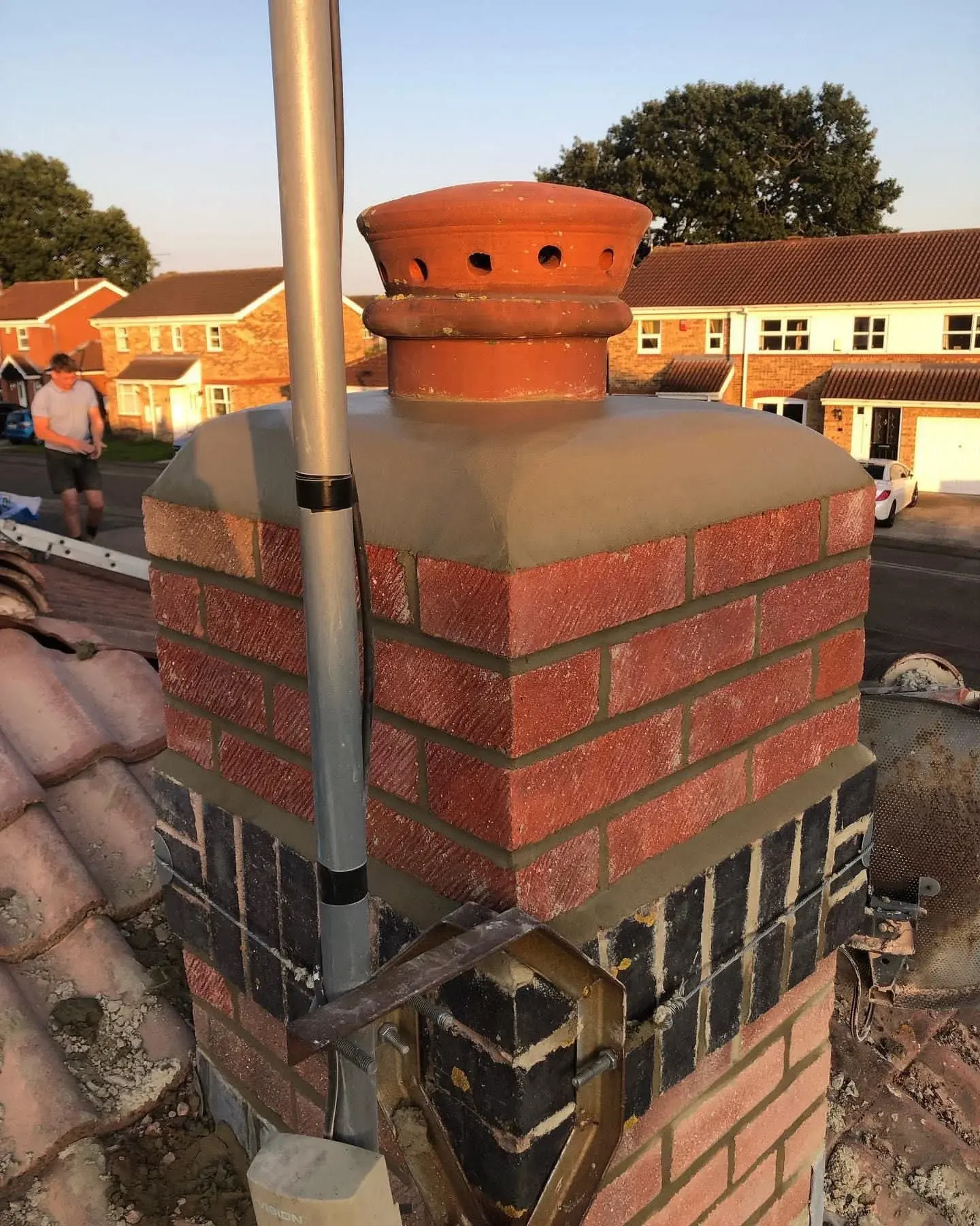 Rebuilt and repointed brick chimney stack with new flaunching, pot and flue liner