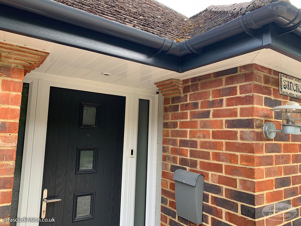 New anthracite grey guttering with white UPVC fascias and soffits on a brick home